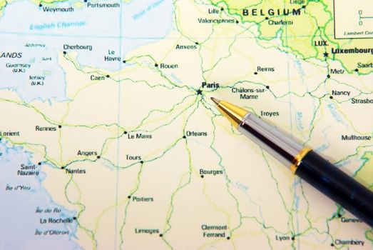 Ballpoint pen on France map, showing Paris.