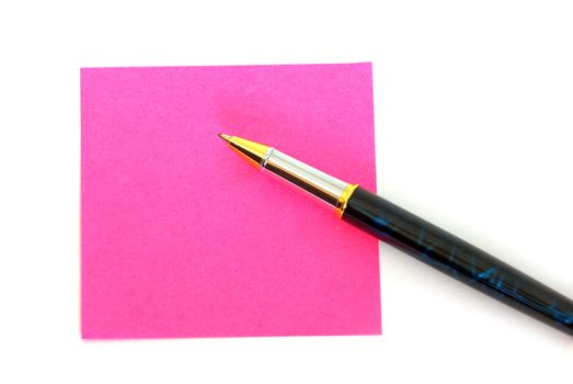 Making a note on a pink post it.