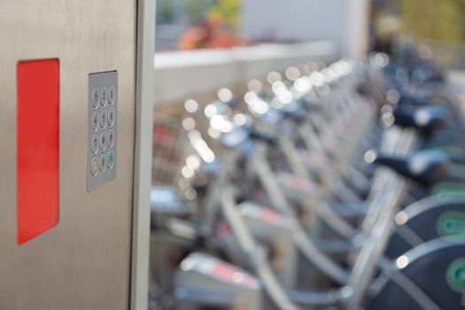 Station of urban bicycles for rent downtown. Green sustainable ecological public transport. Healthy lifestyle.