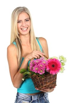 Beautiful young lady with a basket of colorful flowers