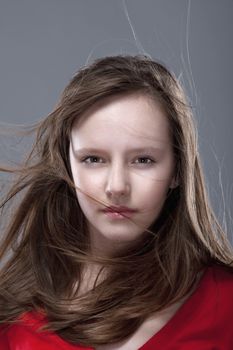 studio shot of an eleven years old girl posing as a fashion model