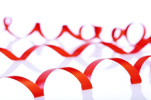 red decorative ribbon in curvy lines isolated on white