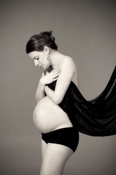 expecting woman - studio shot of a pregnant woman with cloth