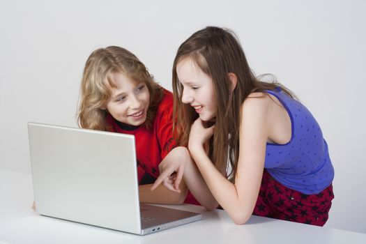 young boy and girl having fun with laptop computer