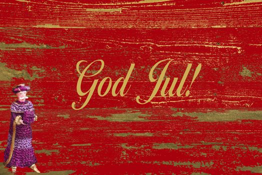 The Scandinavian text: God Jul against a worn red wooden background with a male ornament