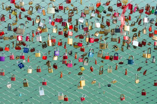 A many of locks on the bridge which the friends or lovers hanging as a symbol of loyalty and eternal love