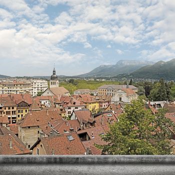 Annecy cityscape with red roof of traditional houses under sky in France.