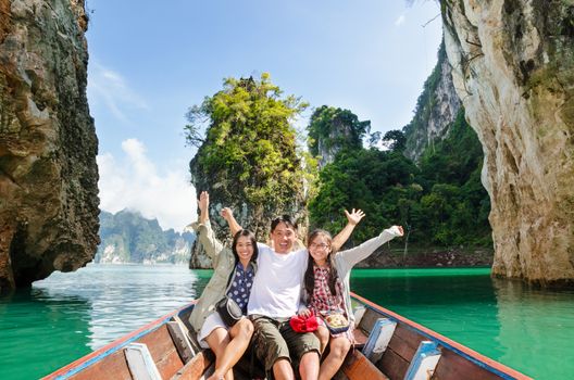 Happy family boat trip on summer vacation in Ratchaprapha Dam, Khao Sok National Park, Surat Thani Province, Thailand ( Guilin of Thailand )
