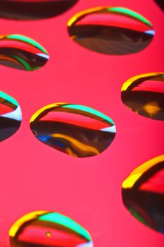 extreme closeup of waterdrops reflecting colors