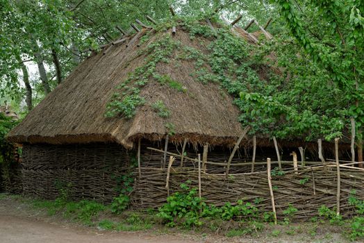 Traditional farmer's barn under the thatch roof in open air museum, Kiev, Ukraine