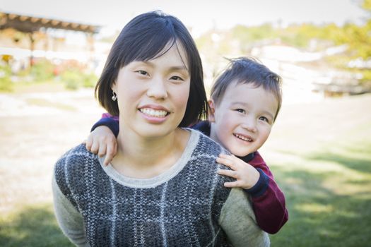 Happy Chinese Mother Having Fun with Her Mixed Race Baby Son.