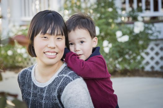 Happy Chinese Mother Having Fun with Her Mixed Race Baby Son.