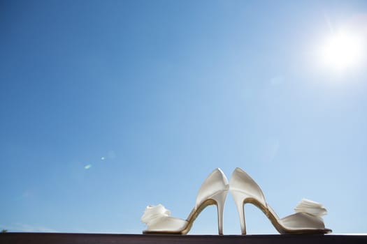 white wedding shoes with a bow . Close up