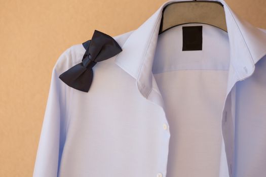 groom shirt on a hanger with a bow tie