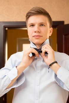 Elegant young handsome groom. The fashion portrait.