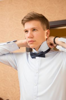 Elegant young handsome groom. The fashion portrait.