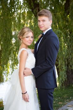 Beautiful wedding couple is enjoying wedding in the sun. 