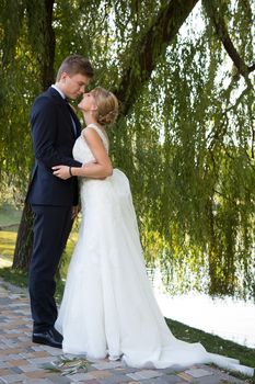 Beautiful wedding couple is enjoying wedding in the sun. 