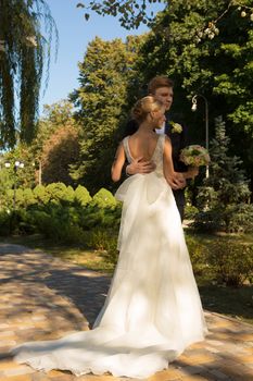 Beautiful wedding couple is enjoying wedding in the sun. 