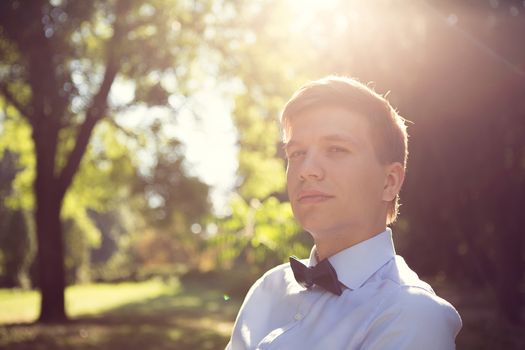 Elegant young handsome groom. The fashion portrait.