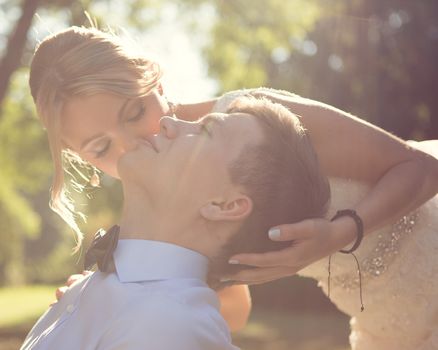 Beautiful wedding couple is enjoying wedding in the sun. 