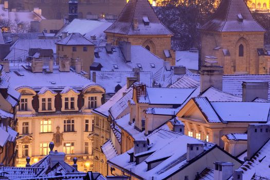 prague - winter view of lesser town rooftops covered with snow