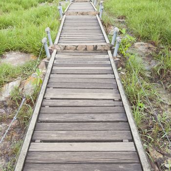 Walkway bridge and up the mountain. Wood bridge go up to the mountain peaks.