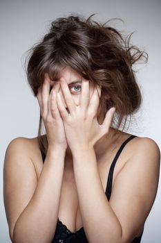 Woman Covering Face with Hand, Looking with One Eye through Fingers