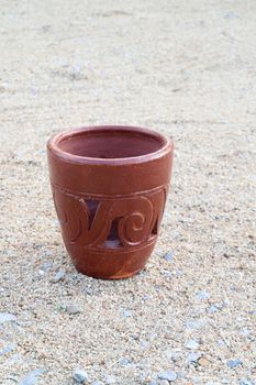 Empty brown pottery on the sand.