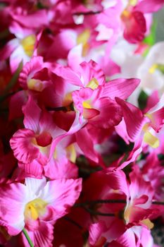 Plastic flower design in pink orchids.