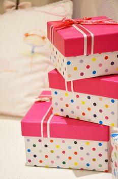Pink gift boxes stack together.