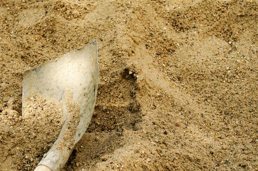 A shovel in a sand close up
