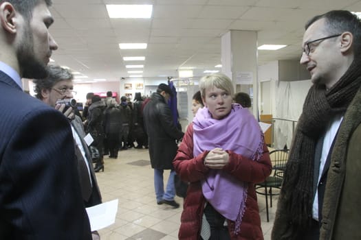 Moscow, Russia - March 4, 2012. Elections in Russia. Policies Evgeniya Chirikova communicates with observers at the polling station