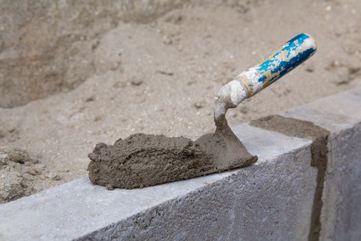 Empty trowel on a constructed wall outdoors