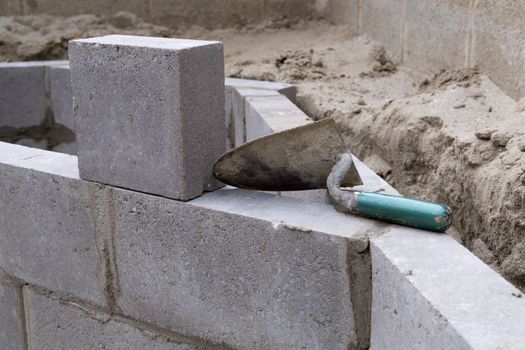 Empty trowel on a constructed wall outdoors