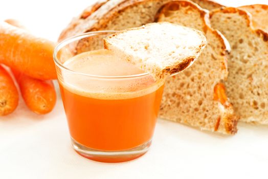 Carrot juice, carrots and carrot bread close up