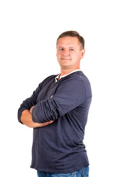 Casually dressed middle aged man with arms folded. 3/4 view of man shot in vertical format isolated on white.