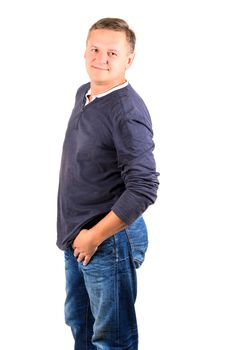 Casually dressed middle aged man smiling. 3/4 view of man shot in vertical format isolated on white.