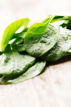 Spinach leaves on wooden background