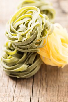 Italian pasta on wooden background