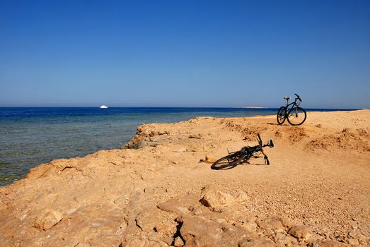 two bicycles on yellow seacoast of the blue Red Sea in Egypt