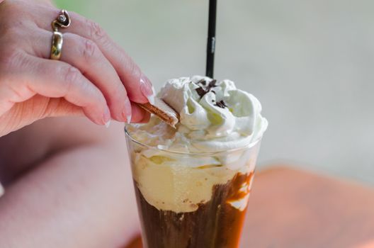 Milk mixed drink, iced coffee, espresso and chocolate. With cocoa powder and whipped cream.