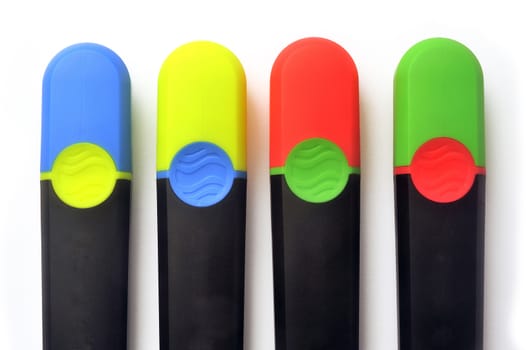 Blue, green, red and yellow highlighters with caps inversion on white background