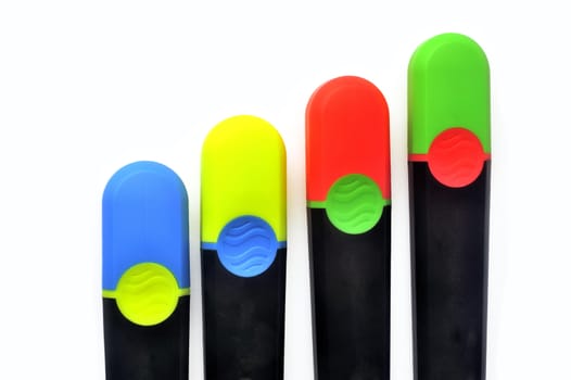 Blue, green, red and yellow highlighters with caps inversion on white background