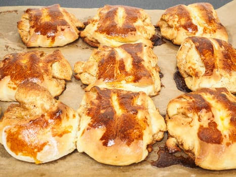 Fresh made cinnamon buns plaited on baking paper