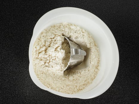 Measurement tool in a bowl of wheat flour