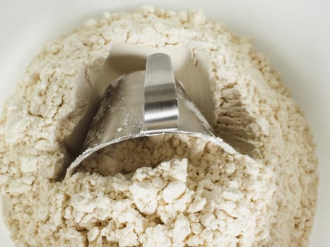 Measurement tool in a bowl of wheat flour