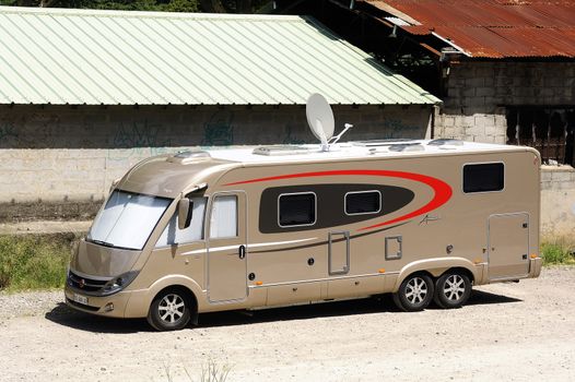 A large motorhome parked at the station Anduze time for homeowners to make the trip by the tourist steam train.