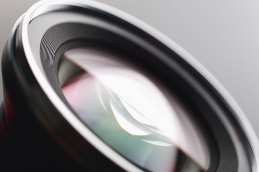 Camera lens close-up on gray background