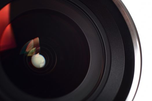 Camera lens close-up on white background